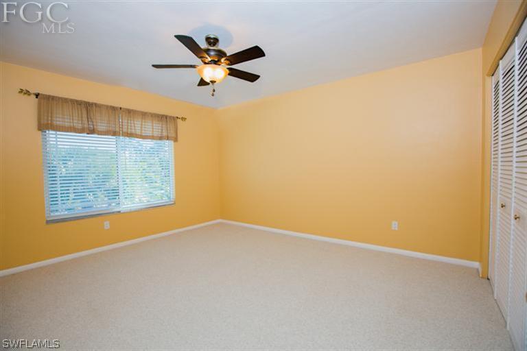 1342 Sand Castle Road Sanibel, FL 33957 - Photo 9 of 17 an empty room with a window and a ceiling fan