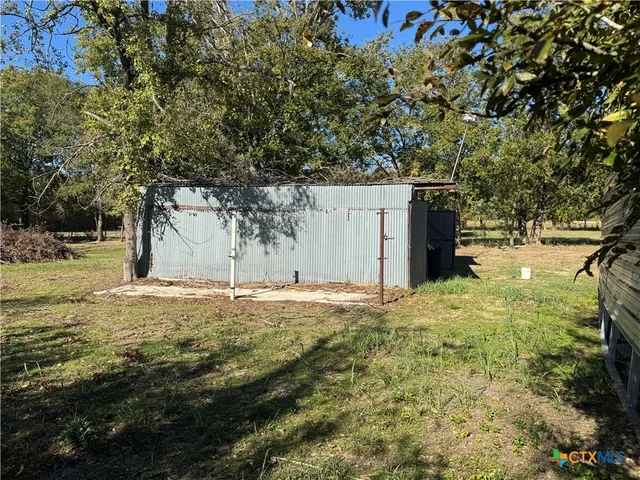 a view of a yard with a tree