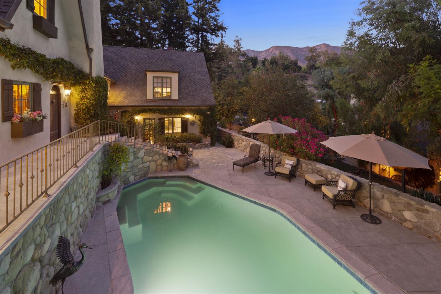 267 Fairview Road Ojai, CA 93023 - Photo 46 of 50 a view of a swimming pool with lawn chairs under an umbrella