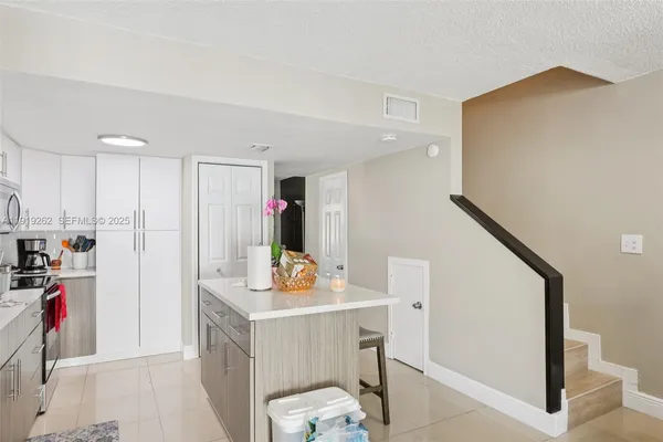 a view of kitchen with furniture and wooden floor