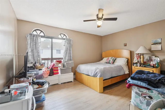 a bedroom with bed and a chandelier
