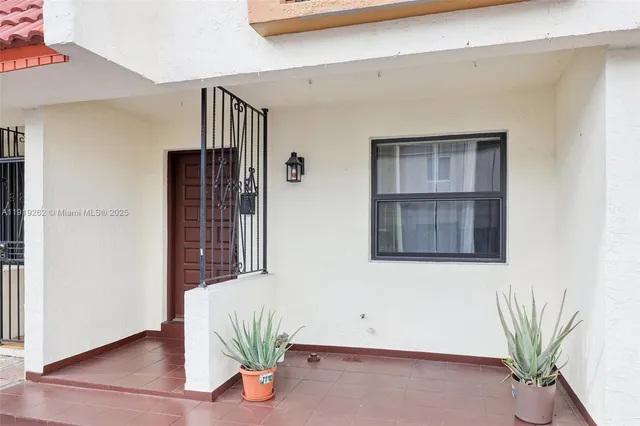 a view of front door and potted plant