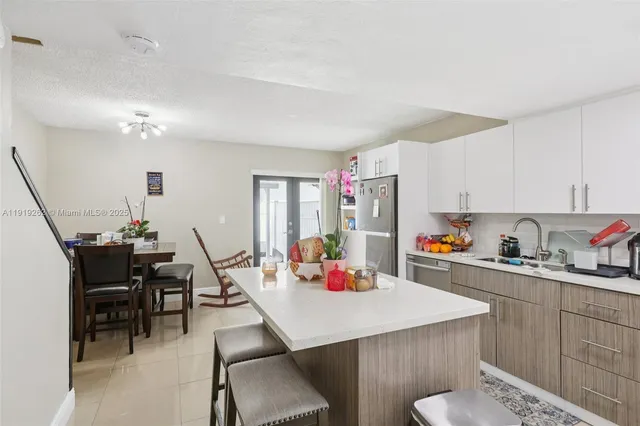 a view of a kitchen with dining table and chairs