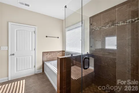 a bathroom with a bathtub and shower