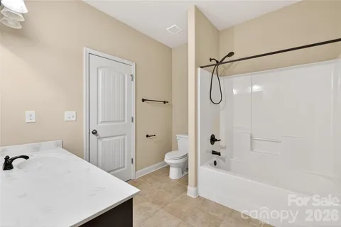 a bathroom with a bathtub shower sink and toilet