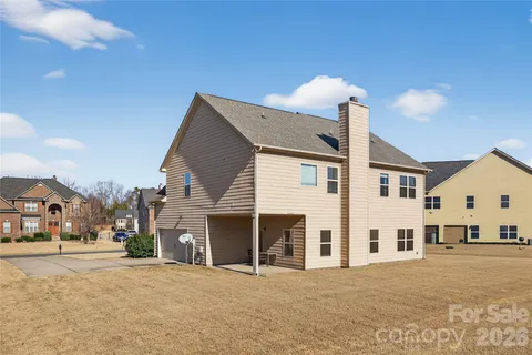 a view of a white house with a street