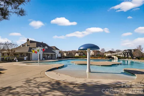 a swimming pool with outdoor seating and yard