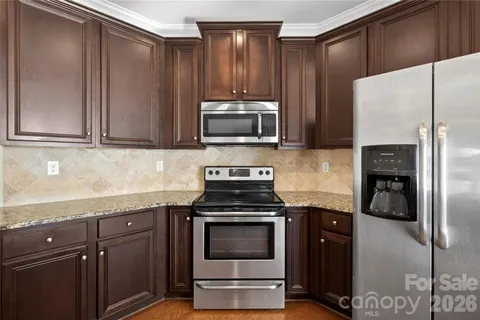 a kitchen with granite countertop cabinets and steel stainless steel appliances