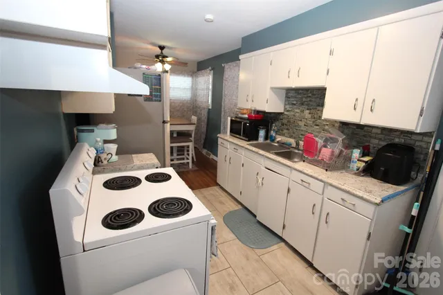 a utility room with sink dryer and washer