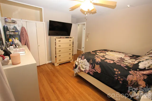 a bedroom with a bed and flat tv screen