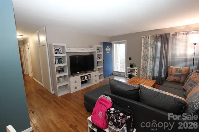 a kitchen with a table chairs and refrigerator