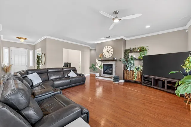 a living room with furniture a fireplace and a flat screen tv