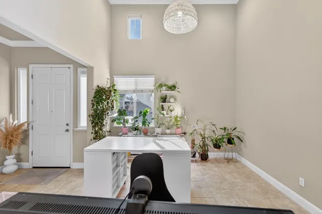 a dining room with furniture and a potted plant