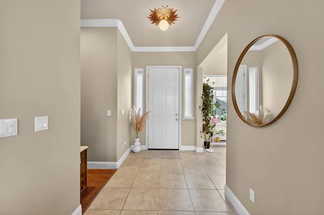 a view of a livingroom with furniture and a chandelier fan