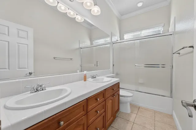 a spacious bedroom with a bed and a chandelier