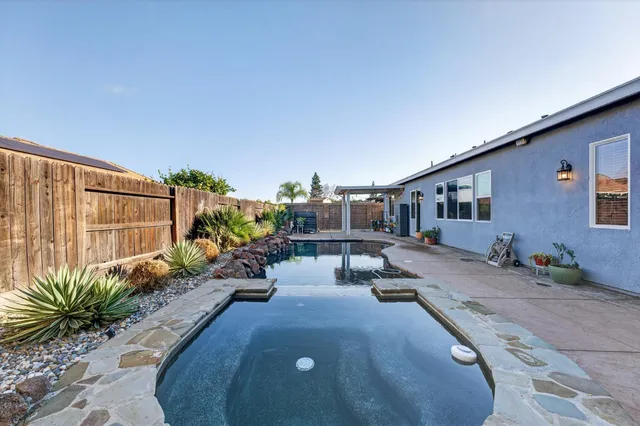 a view of a backyard with plants and a patio