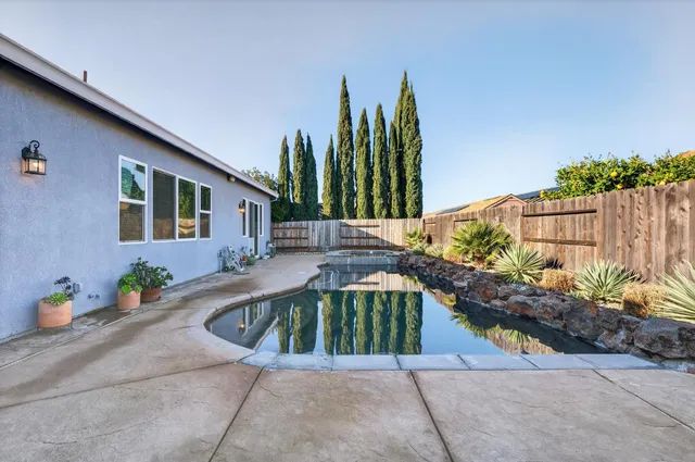 a view of a house with backyard and sitting area