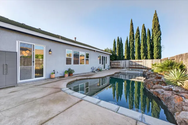 a view of a couches in patio and swimming pool