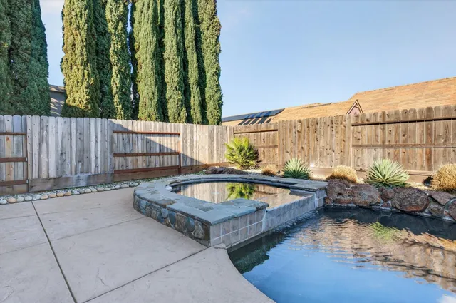 a view of swimming pool with outdoor seating and plants