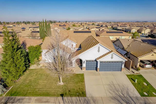 an aerial view of a house with a yard