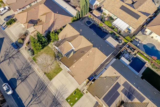 an aerial view of residential houses with outdoor space