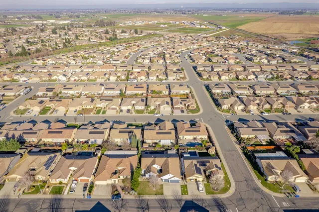 an aerial view of residential houses with outdoor space