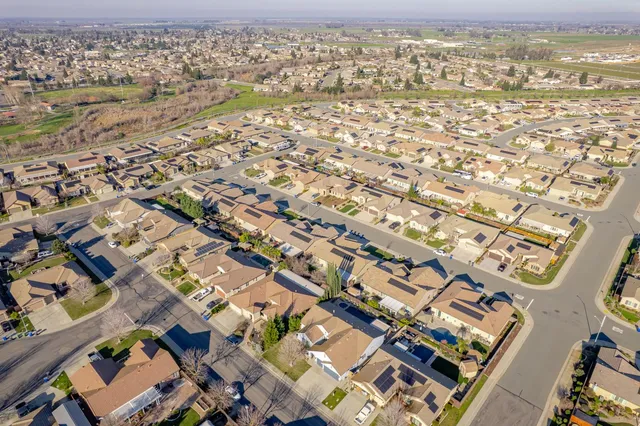 an aerial view of residential houses with outdoor space