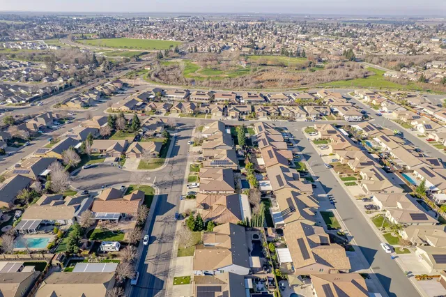 an aerial view of residential houses with outdoor space