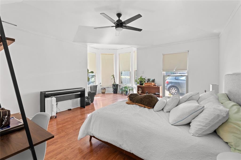 3506 Ruidoso Drive Arlington, TX 76017 - Photo 22 of 37 Spacious room featuring wood-finish flooring, a ceiling fan, and a prominent bay window area