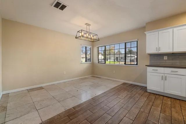 a view of a kitchen with a stove cabinets