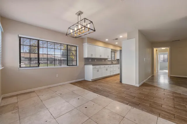 a view of a kitchen with a sink and refrigerator in it