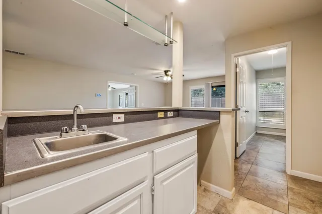 a room with a sink and cabinets