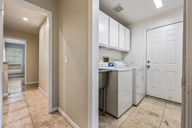 a kitchen with stainless steel appliances granite countertop a sink refrigerator and cabinets
