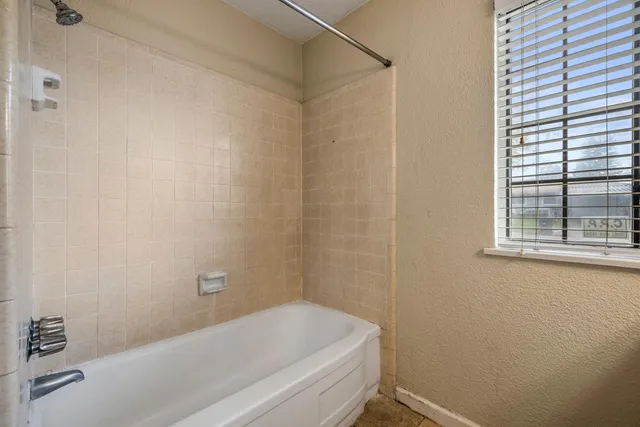a bathroom with a granite countertop shower