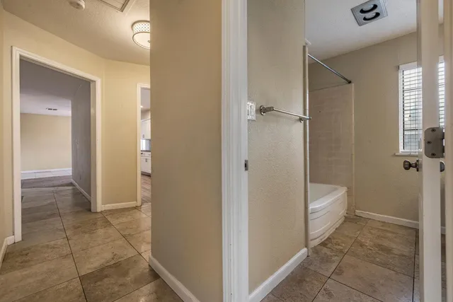 a view of a hallway with wooden floor and closet area