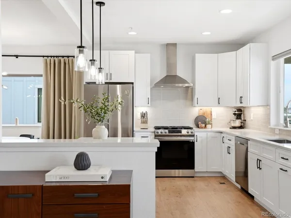 a kitchen with a stove a sink and a refrigerator