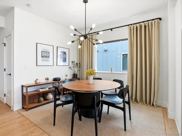 a view of a dining room with furniture and a chandelier