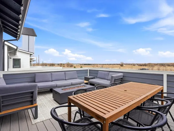 a view of a patio with a table and chairs