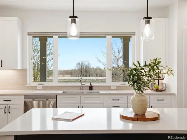 a vase of flowers sitting on a table with a window