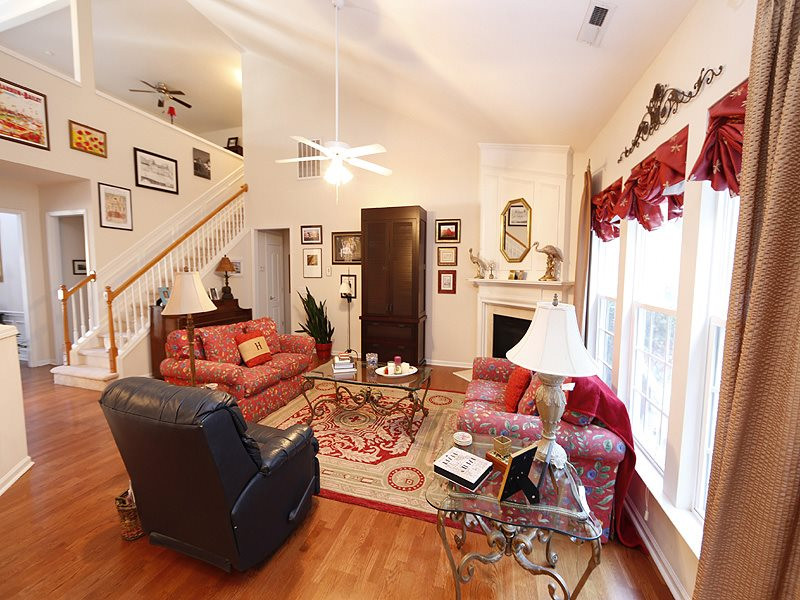 Spacious living room with vaulted ceiling and fireplace Living Room