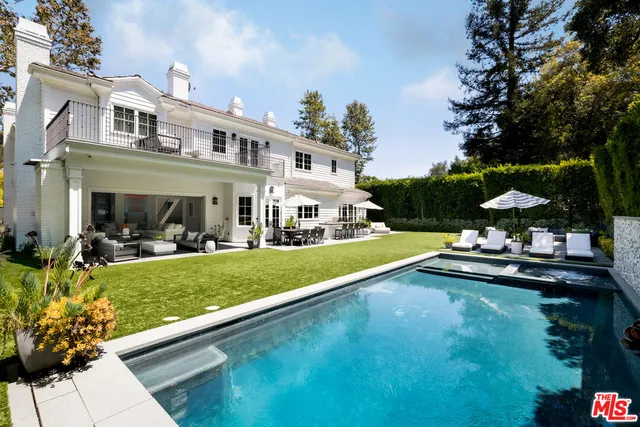 a view of swimming pool with outdoor seating and a garden