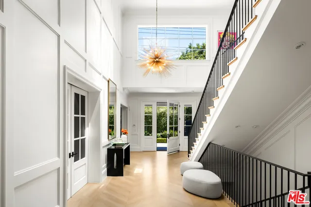 a view of an entryway with wooden floor and door