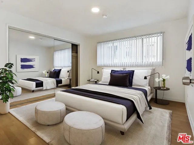 a bedroom with a bed and couch