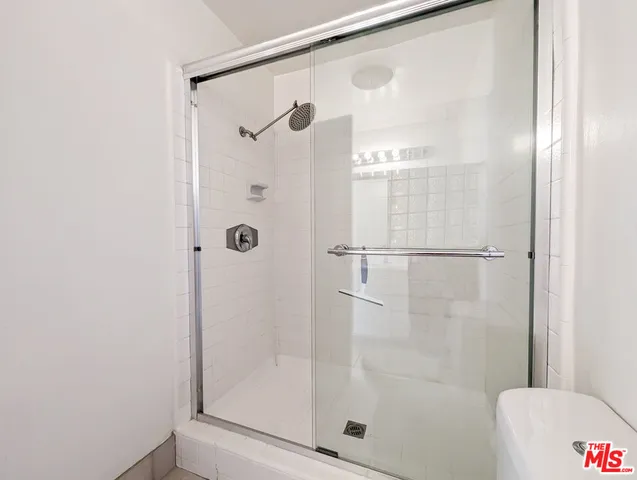 a bathroom with a glass shower door