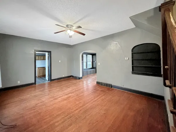 wooden floor in an empty room with a window