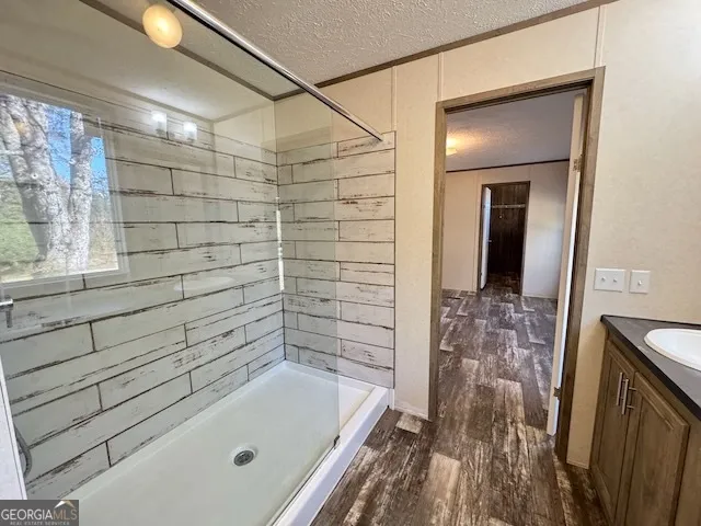 a bathroom with a granite countertop sink toilet and shower