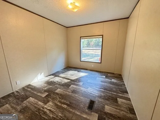 a view of dirt yard with a large tree