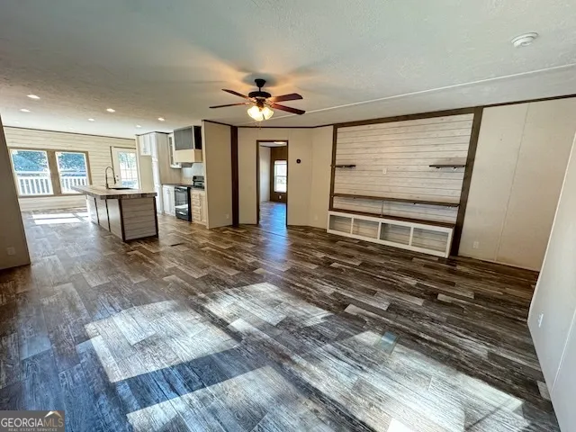 a kitchen with granite countertop sink stove and refrigerator