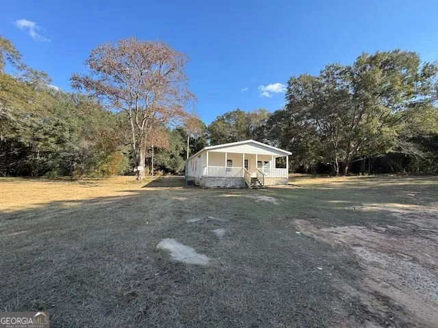a backyard of a house with lots of green space