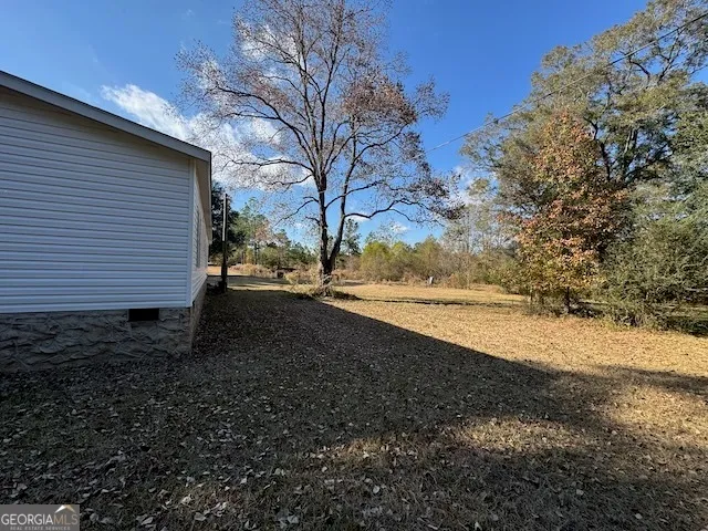 a view of a yard with a tree